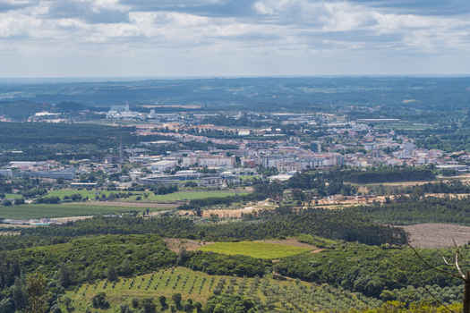 View of the town of Rio Maior nestled among rolling green hills agricultural fields and patches of forest in Rio Maior Santarem Portugal. View of the town of Rio Maior nestled among rolling green hills agricultural fields and patches of forest in Rio Maior Santarem Portugal.