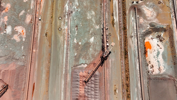 Aerial view of industrial mining site with railway tracks and mineral processing textures Aerial view of industrial mining site with railway tracks and mineral processing textures