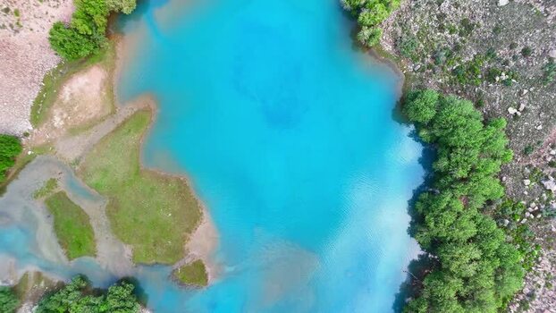 Aerial view of turquoise mountain lake near Vudor Peak Tajikistan.