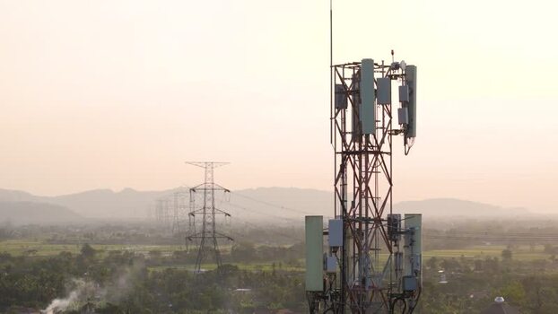 Aerial view of a cell tower and power lines in Indonesia. Aerial view of a cell tower and power lines in Indonesia.
