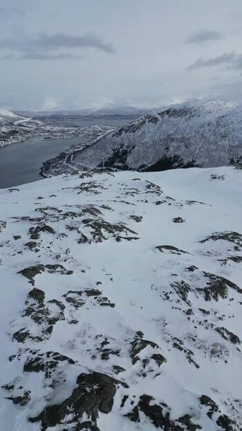 Aerial view of snow covered mountains and fjord on Kvaloya Norway.
