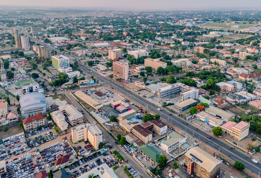 Aerial view of Ahmadu Bello Way featuring urban buildings busy parking lots and green trees under a hazy sky in Kaduna Kaduna Nigeria. Aerial view of Ahmadu Bello Way featuring urban buildings busy parking lots and green trees under a hazy sky in Kaduna Kaduna Nigeria.