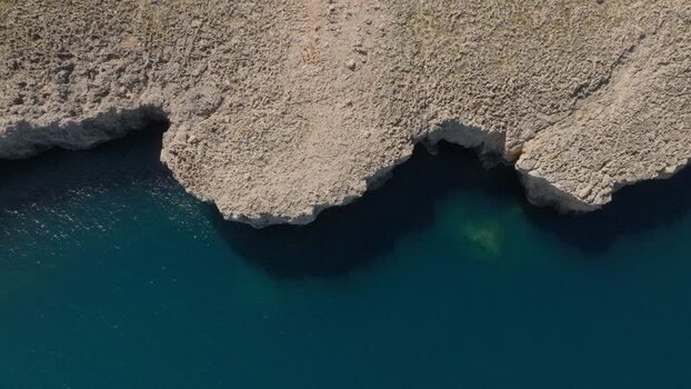 Aerial view of the rugged rocky coastline of Plemmirio Italy.