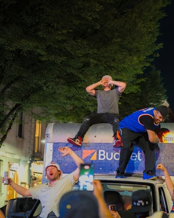 Williamsburg New York USA 14 June 2026 View of fans celebrating the Knicks NBA championship victory while standing on top of a truck in the street at night. Williamsburg New York USA 14 June 2026 View of fans celebrating the Knicks NBA championship victory while standing on top of a truck in the street at night.