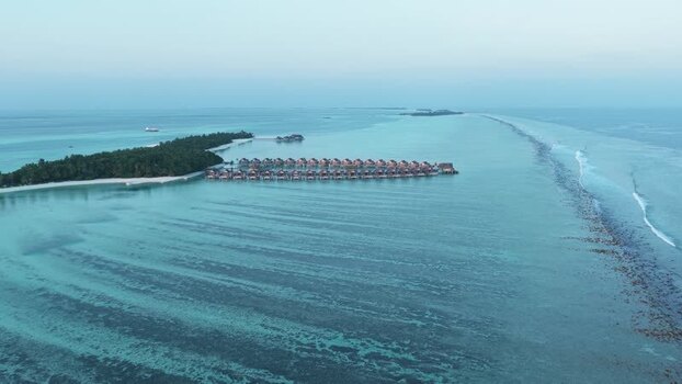 Aerial view of overwater bungalows and turquoise sea Maldives. Aerial view of overwater bungalows and turquoise sea Maldives.