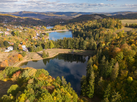 Aerial view of Velka Vindsachta Evickino and Pachomia lakes surrounded by autumn forests and hills in Stiavnicke Bane Banskobystricky kraj Slovakia.