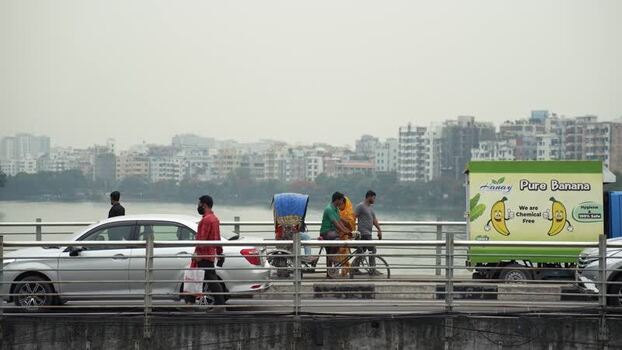 View of traffic and pedestrians on a bridge in Dhaka Bangladesh.