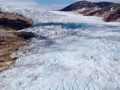 Aerial view of Svartisen glacier in Saltfjellet Svartisen National Park showing deep blue crevasses and rugged mountain terrain in Rana Municipality Nordland Norway.