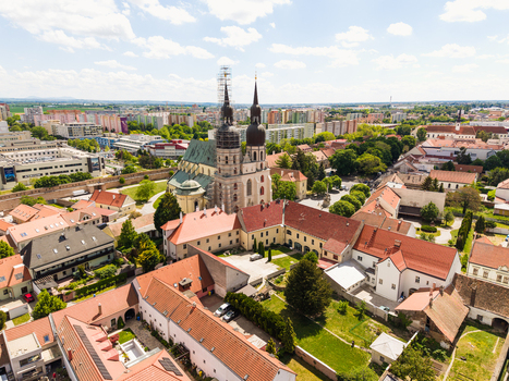 Aerial view of Saint Nicholas Basilica with its twin towers and historic red roofed buildings in Trnava Trnava Region Slovakia. Aerial view of Saint Nicholas Basilica with its twin towers and historic red roofed buildings in Trnava Trnava Region Slovakia.