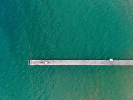 Aerial view of a concrete pier extending into the turquoise waters of the Black Sea in Shkorpilovtsi Varna Bulgaria. Aerial view of a concrete pier extending into the turquoise waters of the Black Sea in Shkorpilovtsi Varna Bulgaria.