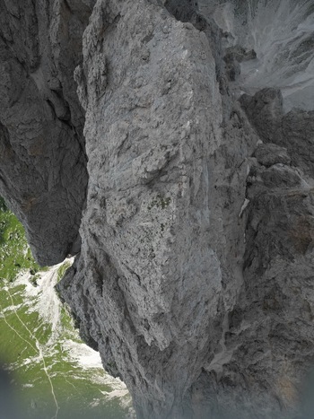 Aerial view of the jagged limestone peaks of the Dolomite Mountains with steep rock faces and green alpine meadows below Canazei Trentino South Tyrol Italy. Aerial view of the jagged limestone peaks of the Dolomite Mountains with steep rock faces and green alpine meadows below Canazei Trentino South Tyrol Italy.