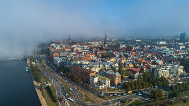 Aerial view of the historic skyline of Riga partially covered by morning fog along the Daugava river in Riga Latvia. Aerial view of the historic skyline of Riga partially covered by morning fog along the Daugava river in Riga Latvia.