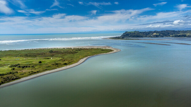 Aerial view of the Ohope Spit and estuary with lush green coastal vegetation sandy beach and calm waters in Ohope Bay of Plenty Region New Zealand. Aerial view of the Ohope Spit and estuary with lush green coastal vegetation sandy beach and calm waters in Ohope Bay of Plenty Region New Zealand.