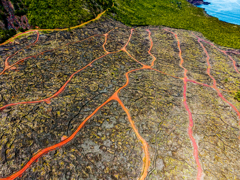 Aerial view of sinuous paths cutting through volcanic rock formations near Miradouro Prainha Pico Azores Portugal. Aerial view of sinuous paths cutting through volcanic rock formations near Miradouro Prainha Pico Azores Portugal.
