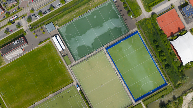 Aerial view of H.C. Rijnvliet sports complex featuring multiple green artificial turf fields and surrounding urban landscape in Utrecht Utrecht Netherlands.