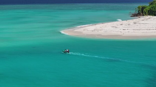 Aerial view of a small boat in turquoise waters near Vashafaru Maldives. Aerial view of a small boat in turquoise waters near Vashafaru Maldives.