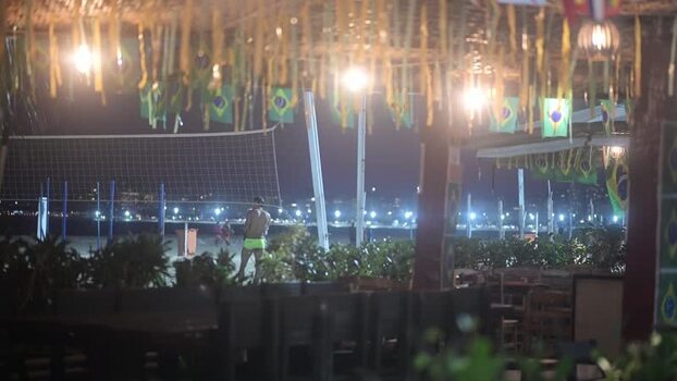 View of Copacabana Beach at night with Brazilian flags Brazil.