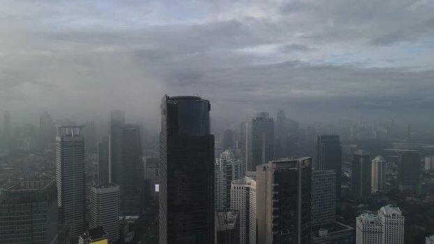 Aerial view of skyscrapers shrouded in mist in Jakarta Indonesia. Aerial view of skyscrapers shrouded in mist in Jakarta Indonesia.