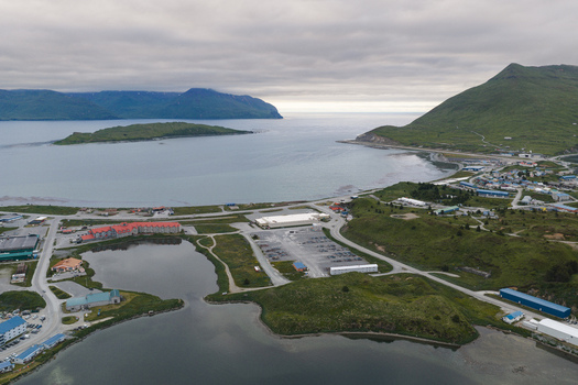 Aerial view of the town of Unalaska nestled between green mountains and the bay in Unalaska Alaska United States.