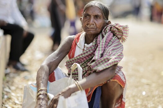Odisha India 26 March 2026 View of an elderly woman with weathered skin and a traditional nose ring sits by the roadside her gaze holding stories of resilience. Odisha India 26 March 2026 View of an elderly woman with weathered skin and a traditional nose ring sits by the roadside her gaze holding stories of resilience.