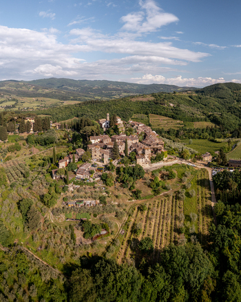 Aerial view of the historic village of Montefioralle surrounded by lush vineyards olive groves and rolling hills in the heart of the Tuscan countryside Montefioralle Tuscany Italy. Aerial view of the historic village of Montefioralle surrounded by lush vineyards olive groves and rolling hills in the heart of the Tuscan countryside Montefioralle Tuscany Italy.