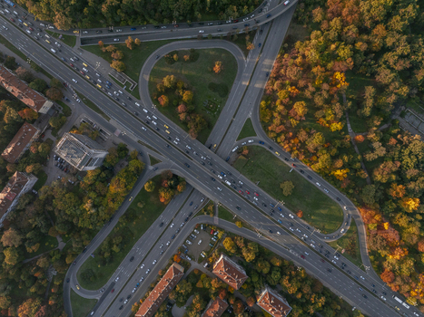 Aerial view of a highway interchange surrounded by vibrant autumn trees and urban buildings in Sofia Sofia City Province Bulgaria.