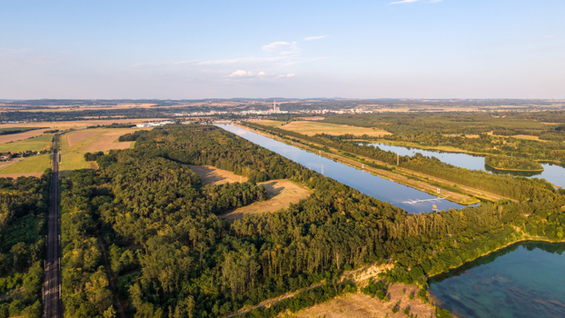 Aerial view of Labe Arena Racice surrounded by lush forests agricultural fields and calm water bodies in Racice Ustecky kraj Czechia. Aerial view of Labe Arena Racice surrounded by lush forests agricultural fields and calm water bodies in Racice Ustecky kraj Czechia.