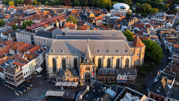 Aerial view of the historic Grote Kerk surrounded by traditional red tiled rooftops and urban architecture in the city center of Zwolle Overijssel Netherlands.
