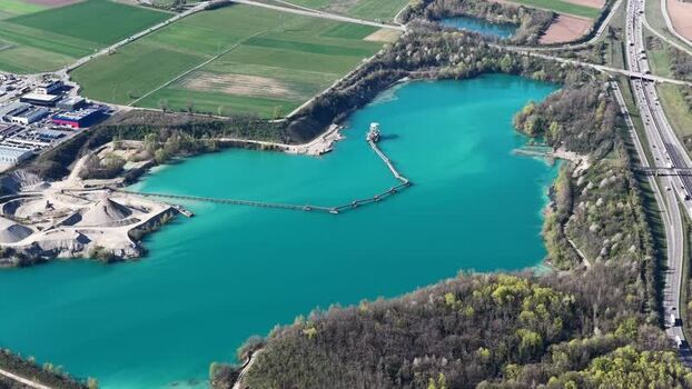 Aerial view of turquoise lake with conveyor France.