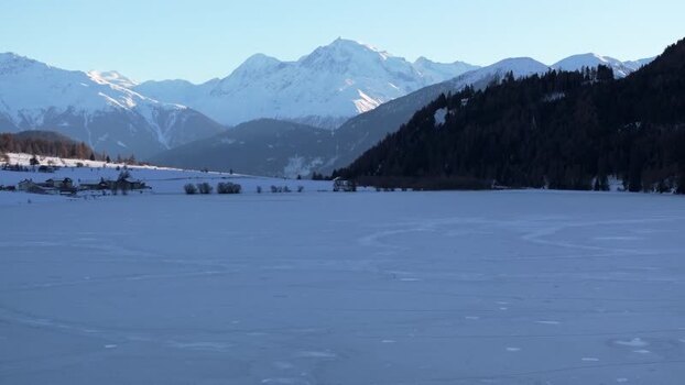 Aerial view of frozen Reschensee lake in the Alps Italy. Aerial view of frozen Reschensee lake in the Alps Italy.