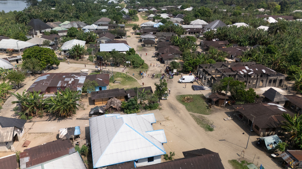 Aerial view of the village of Abua featuring traditional houses dirt roads lush vegetation and a white van parked near a building under construction in Abua Rivers Nigeria. Aerial view of the village of Abua featuring traditional houses dirt roads lush vegetation and a white van parked near a building under construction in Abua Rivers Nigeria.