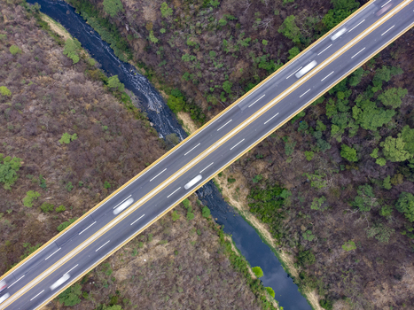 Aerial view of the Autopista Mexico Guadalajara highway bridge crossing over a river and dense forest in Ecuandureo Michoacan Mexico. Aerial view of the Autopista Mexico Guadalajara highway bridge crossing over a river and dense forest in Ecuandureo Michoacan Mexico.