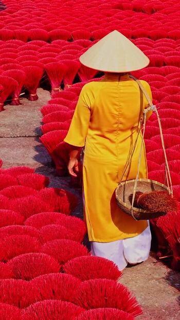 View of a person amidst red incense sticks Vietnam.