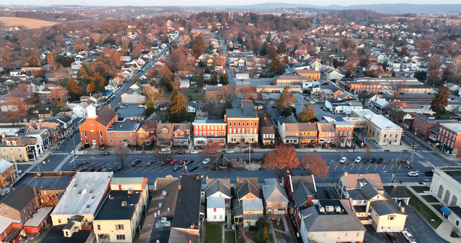 Aerial view of Manheim Square decorated with Christmas lights at dawn featuring historic brick buildings and quiet streets in Manheim Pennsylvania United States. Aerial view of Manheim Square decorated with Christmas lights at dawn featuring historic brick buildings and quiet streets in Manheim Pennsylvania United States.
