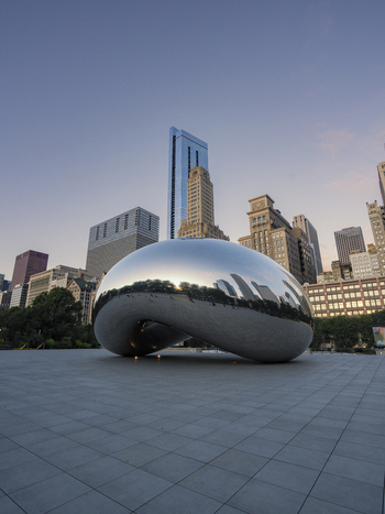 Chicago United States 15 September 2025 View of Cloud Gate sculpture reflecting the city skyline and surrounding skyscrapers in Millennium Park under a clear sky.