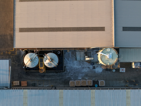 Aerial view of industrial facility with large storage tanks and corrugated metal roofing in Kilsyth South Melbourne VIC Australia. Aerial view of industrial facility with large storage tanks and corrugated metal roofing in Kilsyth South Melbourne VIC Australia.
