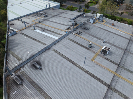 Melbourne VIC Australia 25 September 2026 Aerial view of industrial factory roof with corrugated metal surfaces ventilation units and HVAC equipment.
