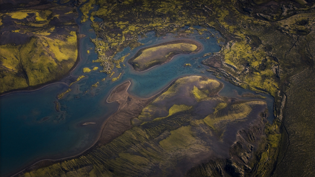 Aerial view of Langisjor lake with its turquoise waters moss covered volcanic terrain and rugged shoreline in Skaftarhreppur Iceland. Aerial view of Langisjor lake with its turquoise waters moss covered volcanic terrain and rugged shoreline in Skaftarhreppur Iceland.