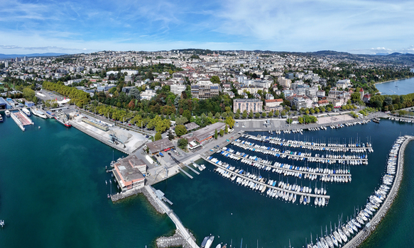 Aerial view of the Ouchy Olympique harbor with numerous sailboats docked in the marina surrounded by the urban landscape of Lausanne Vaud Switzerland. Aerial view of the Ouchy Olympique harbor with numerous sailboats docked in the marina surrounded by the urban landscape of Lausanne Vaud Switzerland.