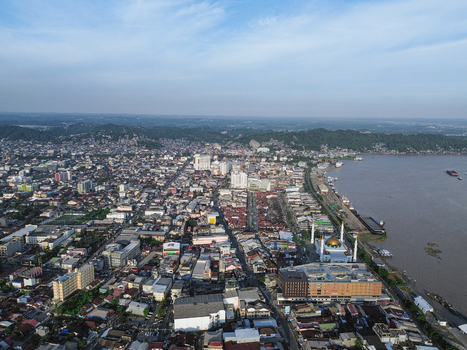 Aerial view of the city of Samarinda with its dense urban landscape the Mahakam River and the prominent Islamic Center Mosque Samarinda Kalimantan Timur Indonesia. Aerial view of the city of Samarinda with its dense urban landscape the Mahakam River and the prominent Islamic Center Mosque Samarinda Kalimantan Timur Indonesia.