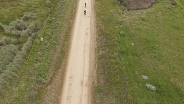 Aerial view of cyclists on a dirt road in South Africa. Aerial view of cyclists on a dirt road in South Africa.