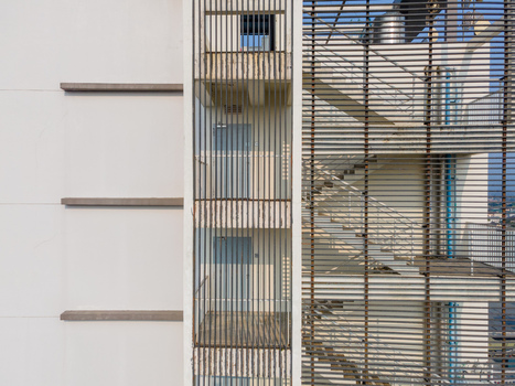 Aerial view of a modern building facade featuring a stairwell enclosed by metal louvers concrete walls and visible doors in Purwokerto Central Java Indonesia. Aerial view of a modern building facade featuring a stairwell enclosed by metal louvers concrete walls and visible doors in Purwokerto Central Java Indonesia.