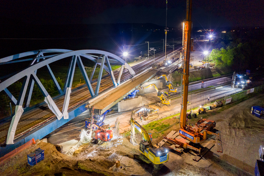 Forchheim Germany 18 May 2024 Aerial view of construction work on the A73 bridge at night with heavy machinery cranes and bright floodlights illuminating the site. Forchheim Germany 18 May 2024 Aerial view of construction work on the A73 bridge at night with heavy machinery cranes and bright floodlights illuminating the site.