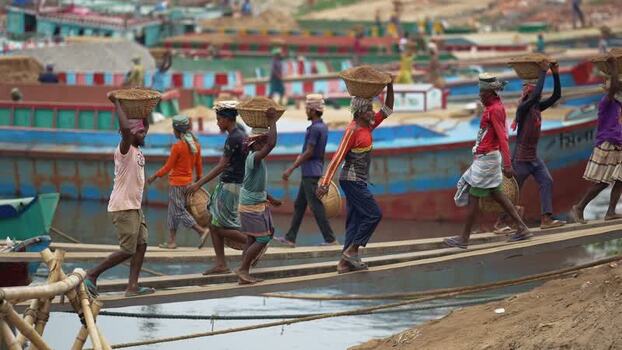 View of workers carrying sand baskets at Aminbazar Bangladesh. View of workers carrying sand baskets at Aminbazar Bangladesh.