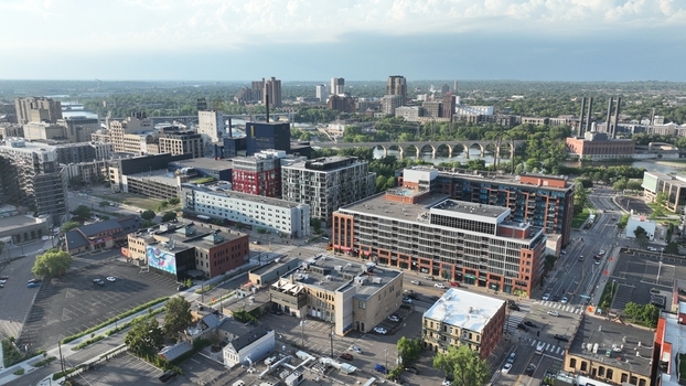 Aerial view of the city s buildings and streets blend under a soft sky with a bridge far away Minneapolis Minnesota United States.