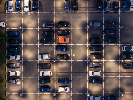 Aerial view of Audi Zentrum Berlin Adlershof parking lot filled with various cars including a bright orange vehicle parked in marked spaces Berlin Berlin Germany.