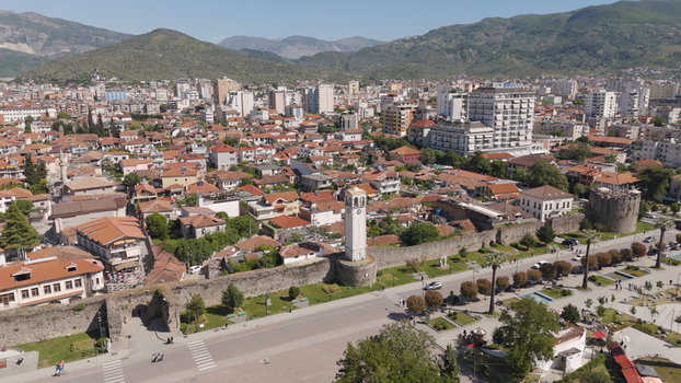 Aerial view of the historic Clock Tower and ancient castle walls of Elbasan surrounded by traditional red tiled rooftops and urban landscape in Elbasan Elbasan County Albania.