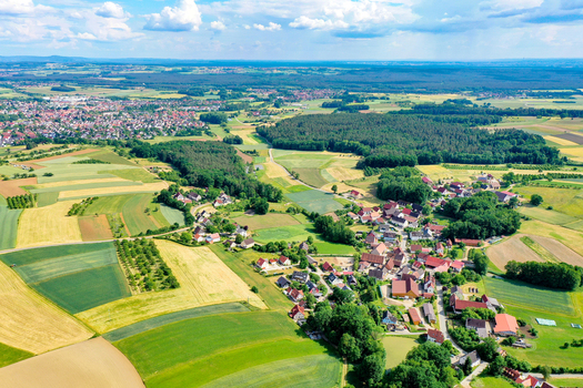 Aerial view of the vast agricultural fields and dense forest patches surrounding the town of Neunkirchen am Brand Bavaria Germany. Aerial view of the vast agricultural fields and dense forest patches surrounding the town of Neunkirchen am Brand Bavaria Germany.