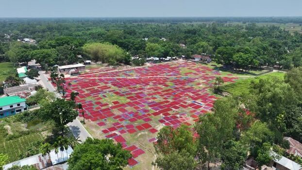 Aerial view of red fabrics drying in a field Bangladesh. Aerial view of red fabrics drying in a field Bangladesh.