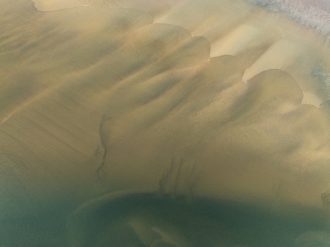 Aerial view of rhythmic patterns etched in the sand by the ocean s gentle caress creating a mesmerizing mosaic of textures and tones Iceland Iceland. Aerial view of rhythmic patterns etched in the sand by the ocean s gentle caress creating a mesmerizing mosaic of textures and tones Iceland Iceland.